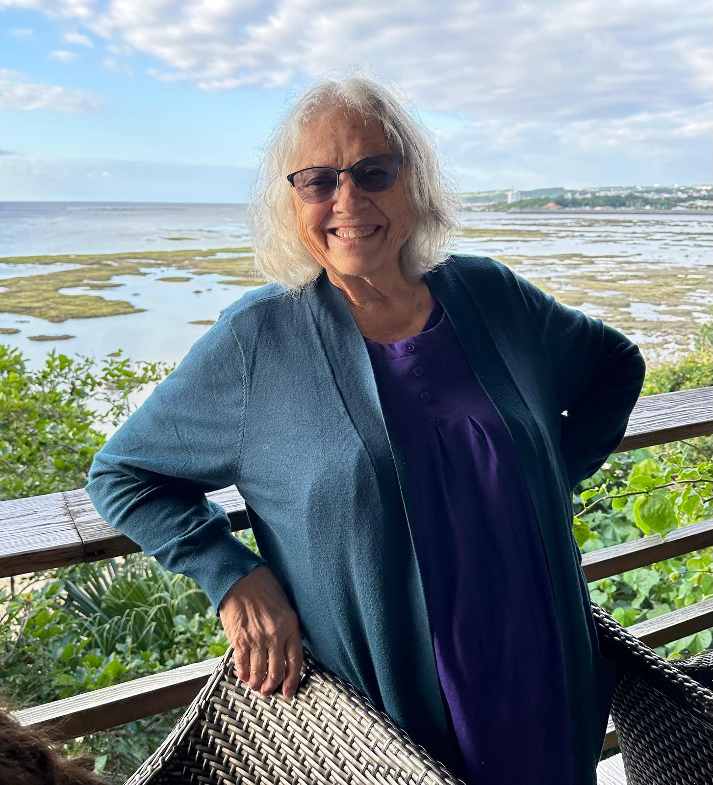 Isara Argent smiling beside the sea in Okinawa