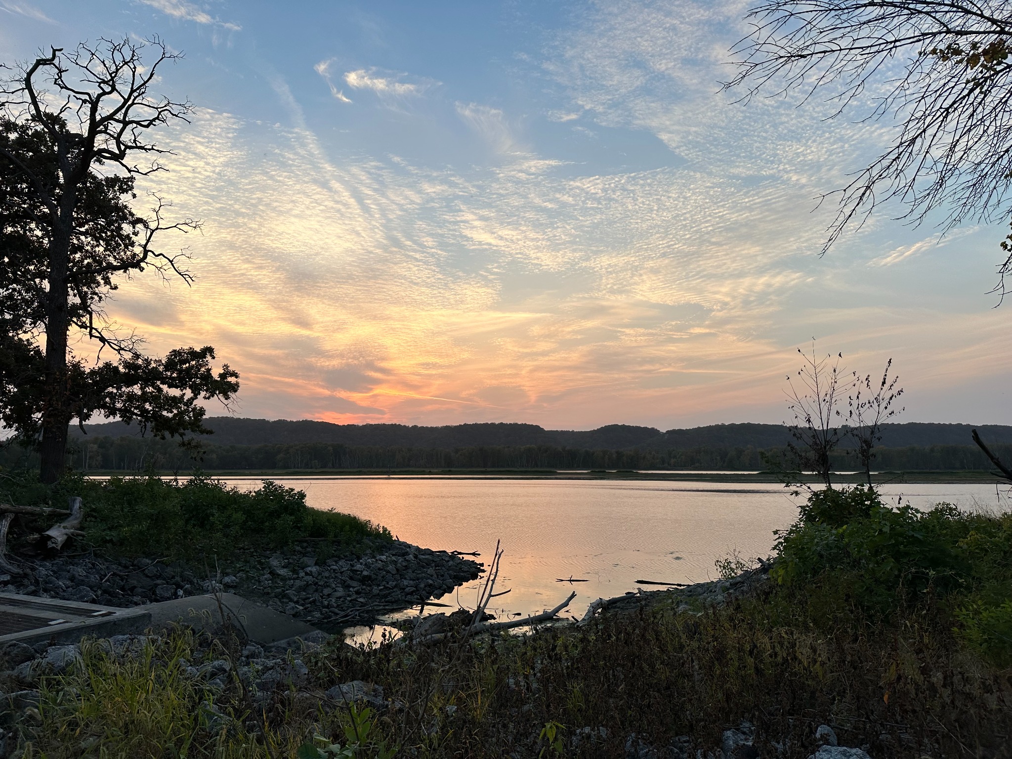 The Mississippi River beneath a wide luminous evening sky